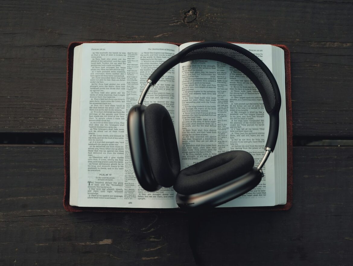 Books and headphones illustrating the launch of audiobook listening and digital publishing.