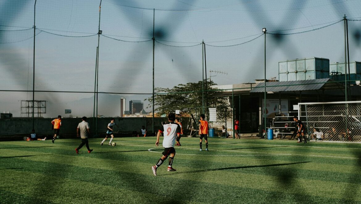 Footballers playing on a pitch; illustrative image, not a photograph of Umar Sadiq.